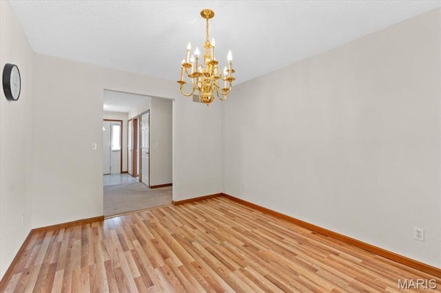2305 Loretta Ln, Collinsville, IL 62234 - unfurnished room with a chandelier, light wood-style floors, and baseboards