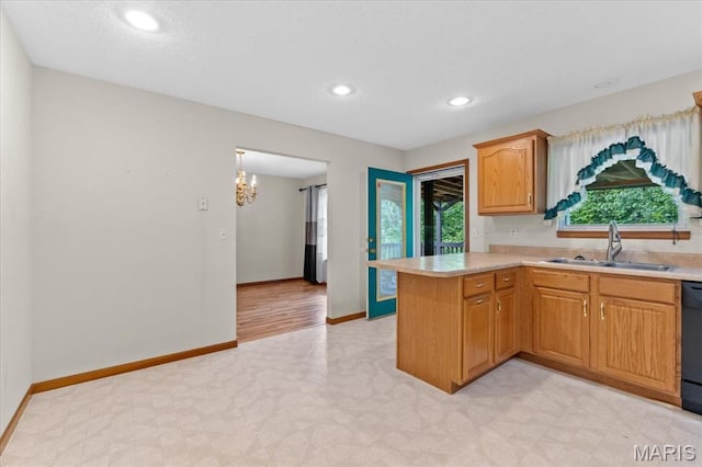 2305 Loretta Ln, Collinsville, IL 62234 - kitchen featuring a sink, light countertops, light flooring, a peninsula, and baseboards