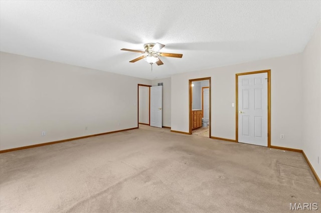 2305 Loretta Ln, Collinsville, IL 62234 - unfurnished bedroom with light carpet, baseboards, connected bathroom, a textured ceiling, and a ceiling fan