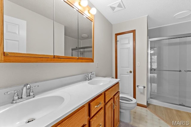 2305 Loretta Ln, Collinsville, IL 62234 - bathroom with a shower stall, tile patterned floors, toilet, double vanity, and a textured ceiling