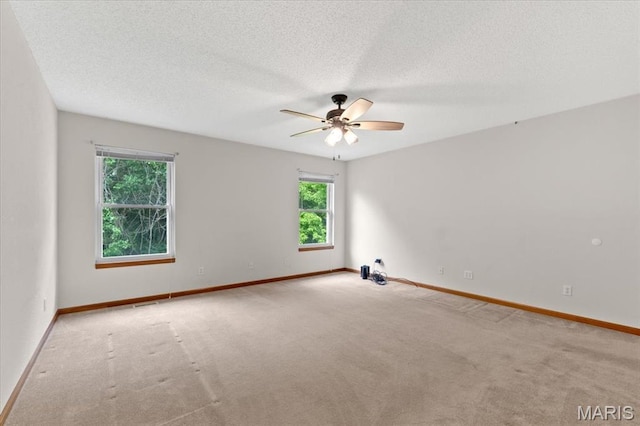2305 Loretta Ln, Collinsville, IL 62234 - carpeted spare room featuring ceiling fan, baseboards, and a textured ceiling