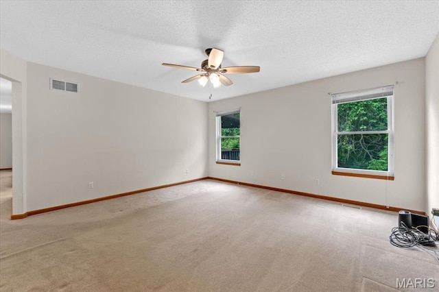 2305 Loretta Ln, Collinsville, IL 62234 - unfurnished room with carpet flooring, a ceiling fan, baseboards, and a textured ceiling