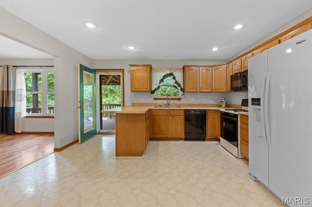 2305 Loretta Ln, Collinsville, IL 62234 - kitchen featuring black appliances, a sink, light countertops, light floors, and a peninsula