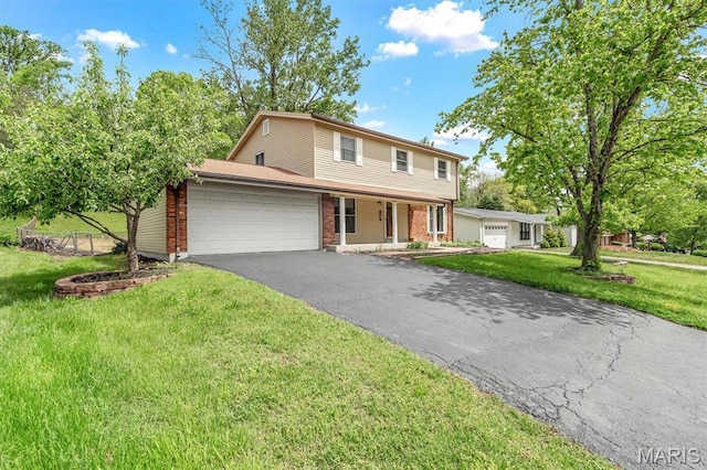 traditional-style home with an attached garage, asphalt driveway, a front lawn, brick siding, and a porch