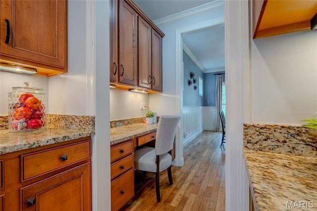 734 Fuhrmann Ter, Glendale, MO 63122 - kitchen featuring crown molding, light wood-type flooring, brown cabinets, light stone counters, and a wainscoted wall