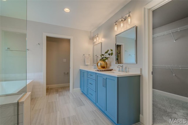 734 Fuhrmann Ter, Glendale, MO 63122 - bathroom featuring a walk in closet, double vanity, and recessed lighting