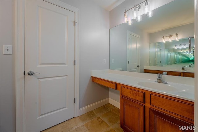 734 Fuhrmann Ter, Glendale, MO 63122 - bathroom featuring baseboards, vanity, and stone finish floors