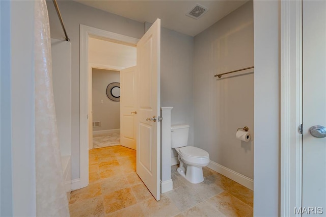 734 Fuhrmann Ter, Glendale, MO 63122 - bathroom featuring toilet, a shower with curtain, and baseboards