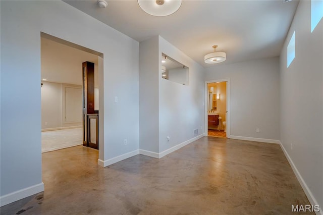 734 Fuhrmann Ter, Glendale, MO 63122 - spare room featuring finished concrete floors and baseboards