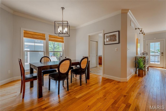 734 Fuhrmann Ter, Glendale, MO 63122 - dining space with healthy amount of natural light, a chandelier, light wood-type flooring, crown molding, and baseboards