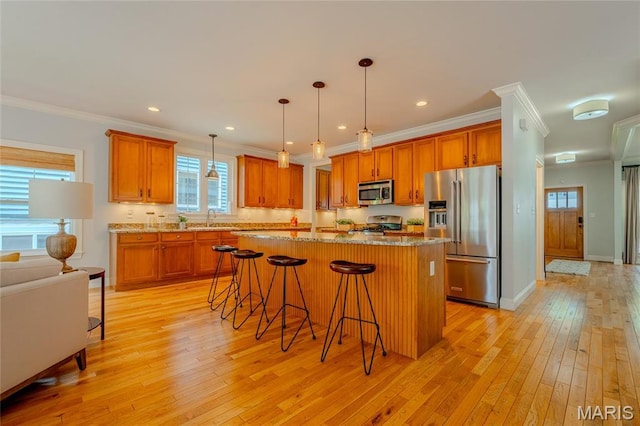 734 Fuhrmann Ter, Glendale, MO 63122 - kitchen featuring appliances with stainless steel finishes, a sink, a center island, crown molding, and light wood finished floors