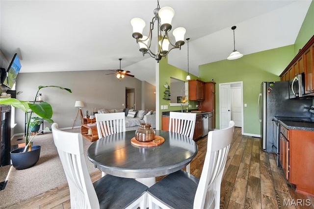 6346 Twin Springs Blvd, Cedar Hill, MO 63016 - dining area featuring lofted ceiling, a ceiling fan, dark wood finished floors, a chandelier, and baseboards