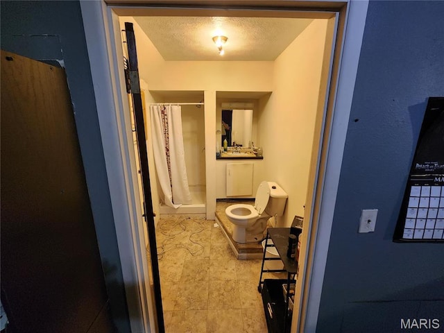 420 E 9th St, Alton, IL 62002 - bathroom with a shower stall, a textured ceiling, and toilet