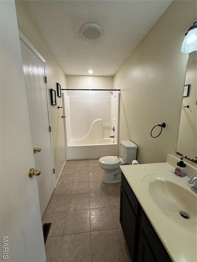 full bathroom featuring shower / bathtub combination, toilet, tile patterned floors, vanity, and a textured ceiling