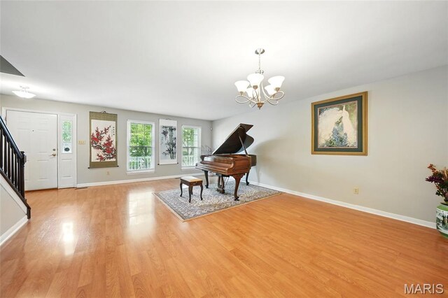 16816 Hickory Trails Ln, Wildwood, MO 63011 - sitting room featuring stairs, light wood-style floors, a chandelier, and baseboards