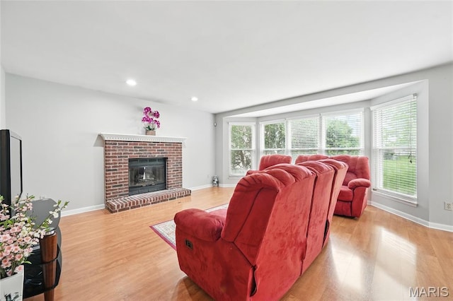 16816 Hickory Trails Ln, Wildwood, MO 63011 - living area featuring light wood-type flooring, baseboards, a brick fireplace, and recessed lighting