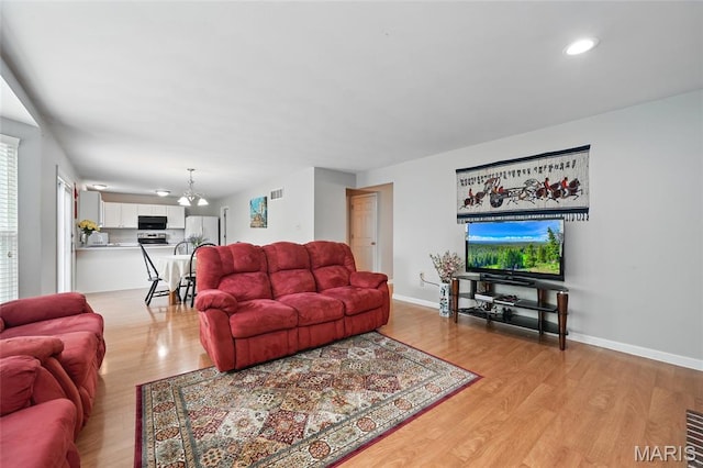 16816 Hickory Trails Ln, Wildwood, MO 63011 - living area featuring light wood-style flooring, a chandelier, baseboards, and recessed lighting