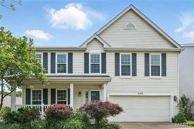 16816 Hickory Trails Ln, Wildwood, MO 63011 - traditional-style house with an attached garage, concrete driveway, and a porch