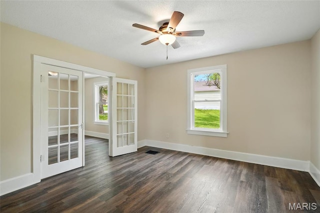 1242 Crystal Heights Rd, Crystal City, MO 63019 - empty room featuring french doors, dark wood finished floors, baseboards, and a textured ceiling