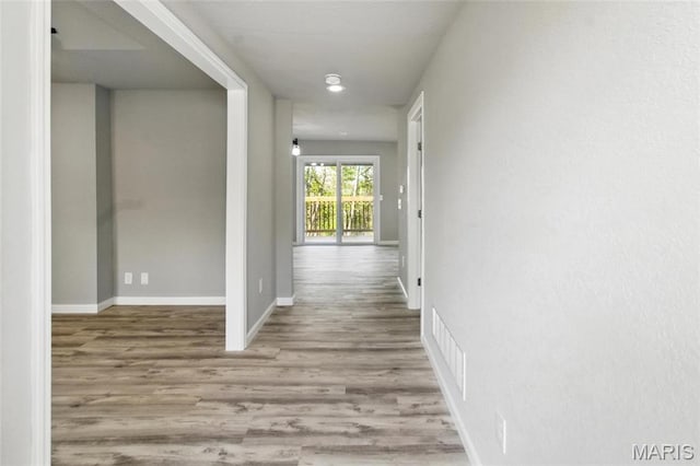619 E 3rd St, De Soto, MO 63020 - hallway featuring wood finished floors and baseboards