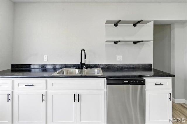 619 E 3rd St, De Soto, MO 63020 - kitchen featuring dishwasher, open shelves, a sink, dark countertops, and white cabinets