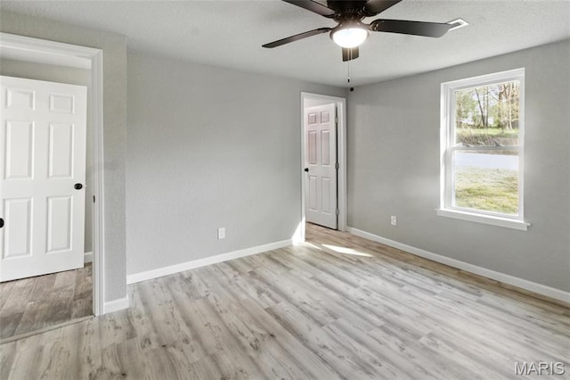 619 E 3rd St, De Soto, MO 63020 - unfurnished bedroom featuring wood finished floors, baseboards, and ceiling fan