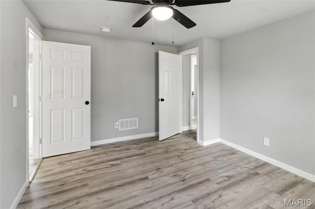 619 E 3rd St, De Soto, MO 63020 - unfurnished bedroom with wood finished floors, baseboards, and a ceiling fan