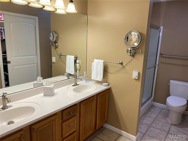 7 Chester Rd, Hannibal, MO 63401 - bathroom with toilet, tile patterned floors, double vanity, a shower with door, and baseboards
