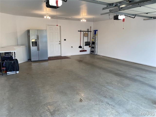 7 Chester Rd, Hannibal, MO 63401 - garage with stainless steel refrigerator with ice dispenser and a garage door opener