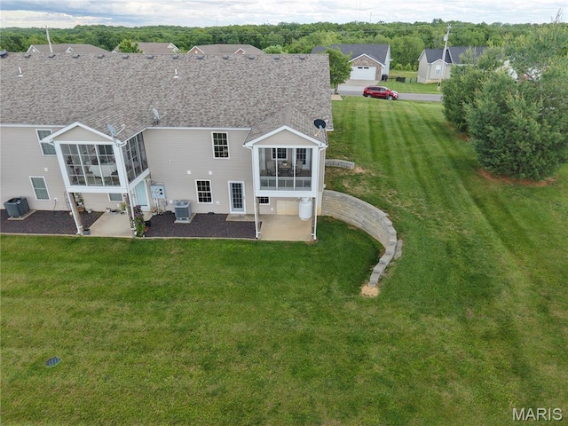 7 Chester Rd, Hannibal, MO 63401 - back of property featuring a sunroom, a patio, central AC unit, and a yard