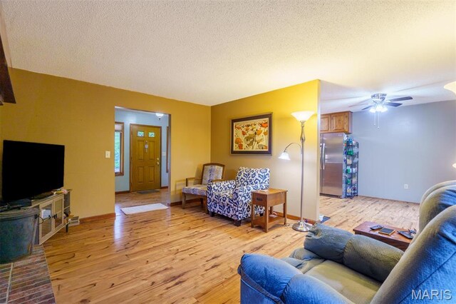 10280 County Road 3110, Rolla, MO 65401 - living area with light wood-type flooring, ceiling fan, and a textured ceiling