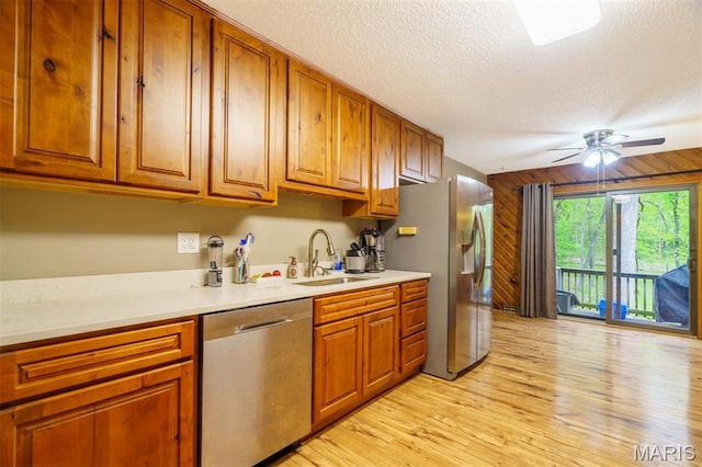 10280 County Road 3110, Rolla, MO 65401 - kitchen featuring stainless steel appliances, a sink, brown cabinets, a textured ceiling, and light countertops