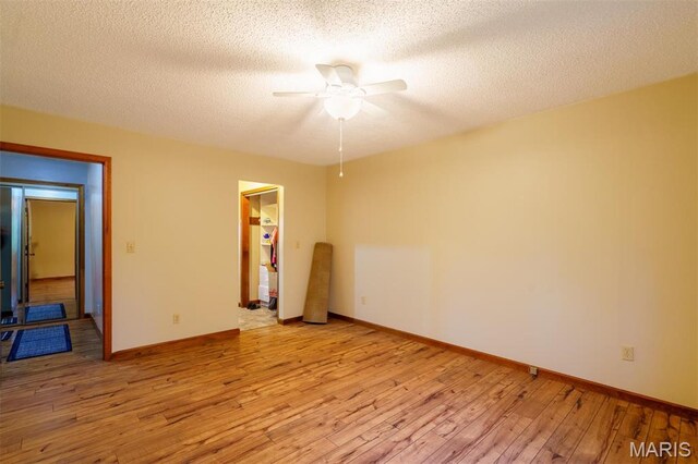 10280 County Road 3110, Rolla, MO 65401 - empty room with ceiling fan, light wood finished floors, baseboards, and a textured ceiling