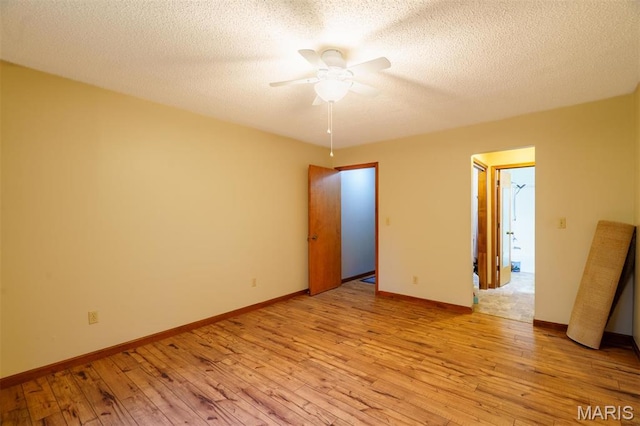 10280 County Road 3110, Rolla, MO 65401 - unfurnished room with ceiling fan, light wood-style flooring, baseboards, and a textured ceiling