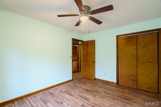 10280 County Road 3110, Rolla, MO 65401 - unfurnished bedroom featuring baseboards, light wood-style floors, a closet, and a ceiling fan