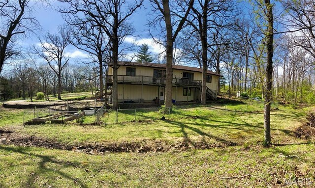 10280 County Road 3110, Rolla, MO 65401 - back of property featuring stairs, a wooden deck, and a garden