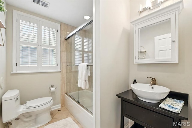 full bath featuring toilet, tile patterned floors, enclosed tub / shower combo, and vanity
