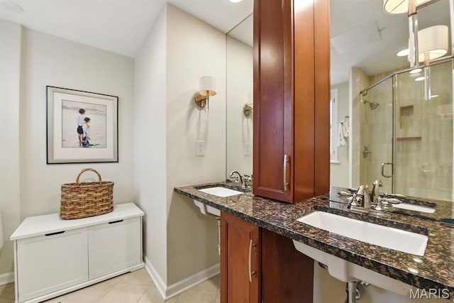 full bathroom with a stall shower, baseboards, and tile patterned floors