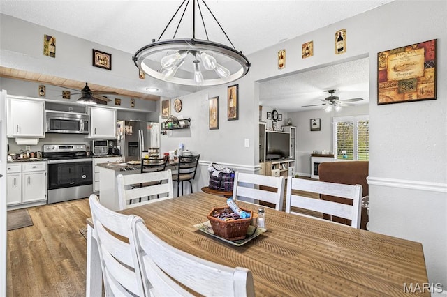 809 Cottage Rd, Bonne Terre, MO 63628 - dining area featuring ceiling fan, light wood-type flooring, a textured ceiling, and a chandelier
