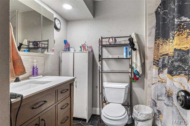 809 Cottage Rd, Bonne Terre, MO 63628 - bathroom with a textured wall, toilet, vanity, a shower with shower curtain, and tile patterned floors