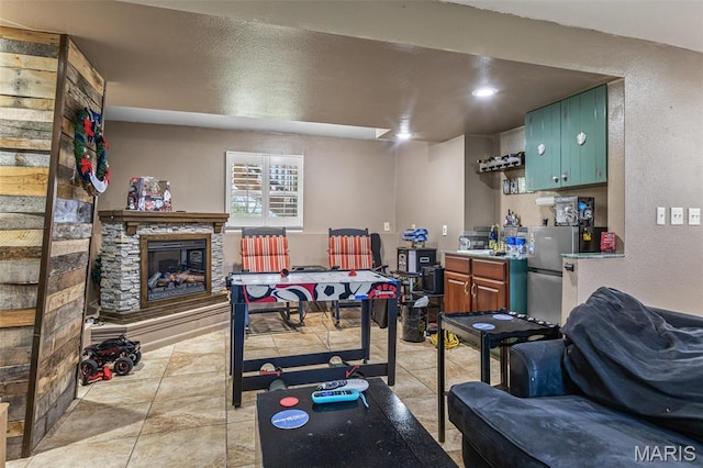 809 Cottage Rd, Bonne Terre, MO 63628 - playroom with a textured wall, a fireplace, a sink, and light tile patterned floors