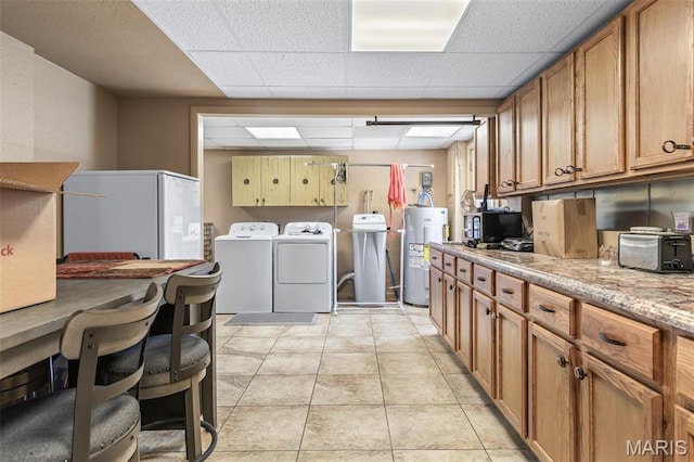 809 Cottage Rd, Bonne Terre, MO 63628 - clothes washing area featuring washing machine and clothes dryer, water heater, and light tile patterned floors