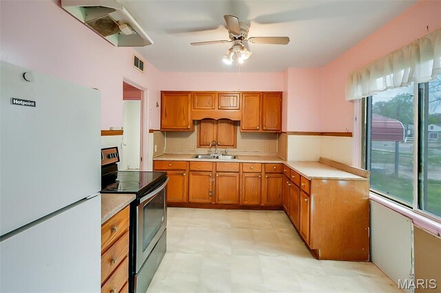 225 Whitelaw Ave, East Alton, IL 62024 - kitchen featuring freestanding refrigerator, electric stove, a sink, and healthy amount of natural light