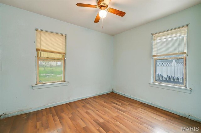 225 Whitelaw Ave, East Alton, IL 62024 - unfurnished room featuring wood finished floors, a ceiling fan, and baseboards