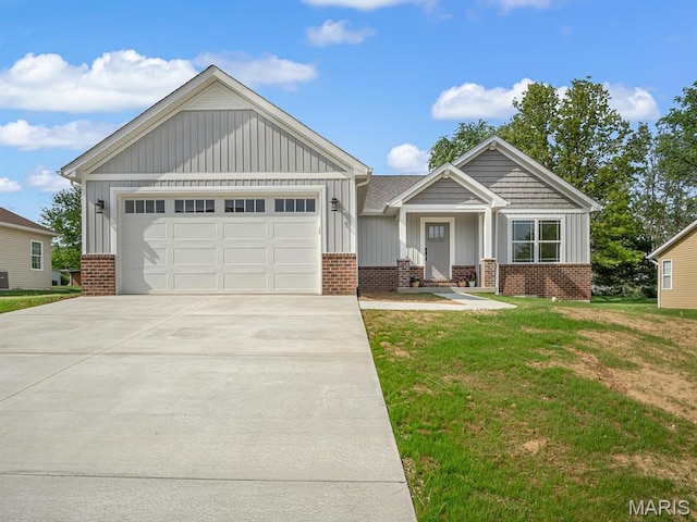 view of front of home with board and batten siding, brick siding, a front yard, and driveway