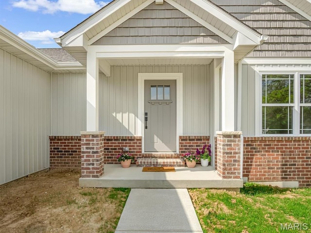 entrance to property featuring brick siding and board and batten siding