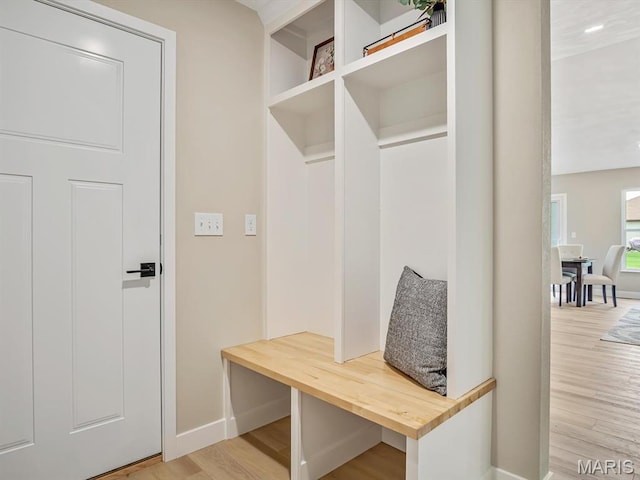 mudroom with baseboards and wood finished floors