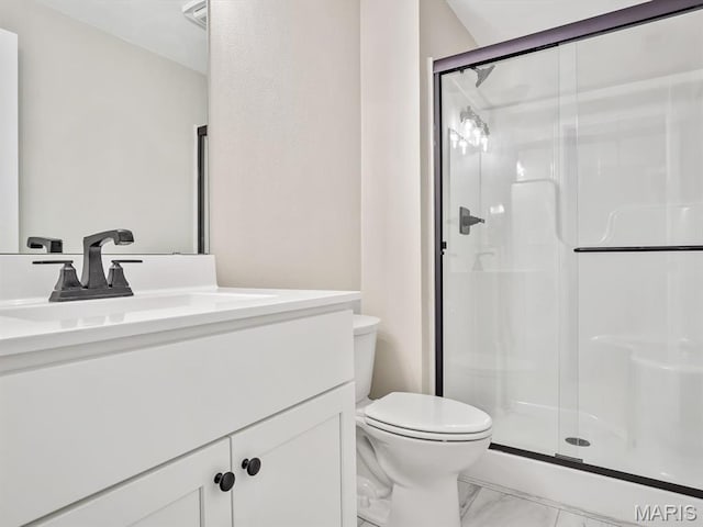 full bath with marble finish floors, toilet, a stall shower, and vanity