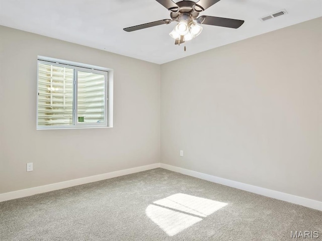 empty room with carpet, baseboards, and ceiling fan