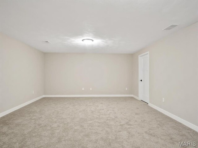 empty room with carpet and baseboards